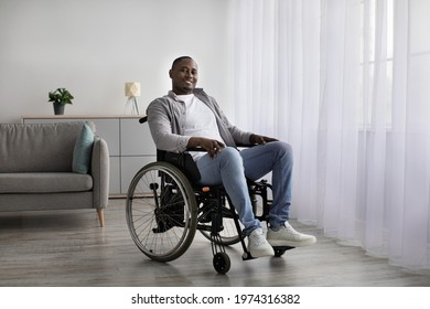 Positive lifestyle, care for disabled person, rehabilitation and support at home during covid-19 lockdown. Glad mature african american man in wheelchair in living room or clinic interior, copy space - Powered by Shutterstock