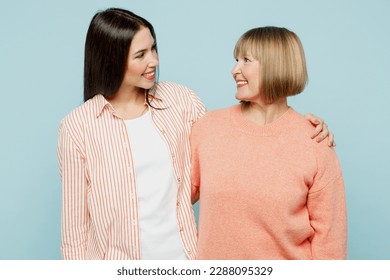 Positive lovely happy fun cheerful elder parent mom with young adult daughter two women together wearing casual clothes hugging look camera isolated on plain blue cyan background. Family day concept - Shutterstock ID 2288095329