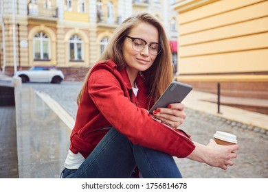 Positive Lovely Woman Using Smartphone And Sending Messages While Resting On Street Banister