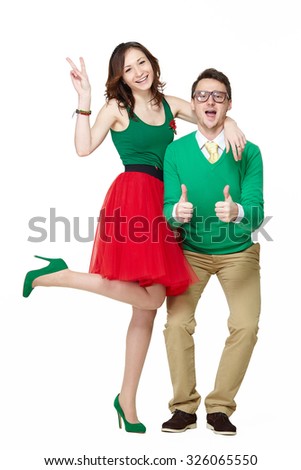 Positive loving couple showing thumbs up. Nerd couple. Interracial young man and woman wearing fifties clothes and eyeglasses. Full body portrait