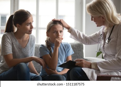 Positive Loving Female Family General Practitioner Comfort Sick Girl Child Do Medical Checkup At Home, Woman Doctor Examine Ill Kid Couching Sneezing, Having Cold, Children Healthcare Concept