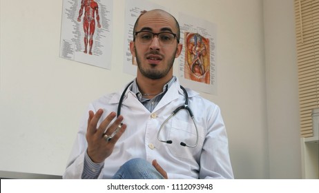 Positive Male Arabian Doctor With Stethoscope Talking To The Camera