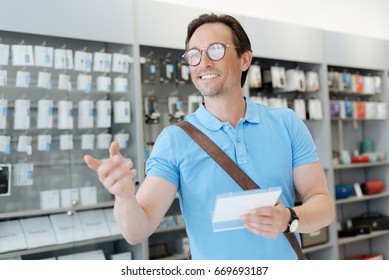 Positive Man Smiling And Pointing His Finger At Electronics Store