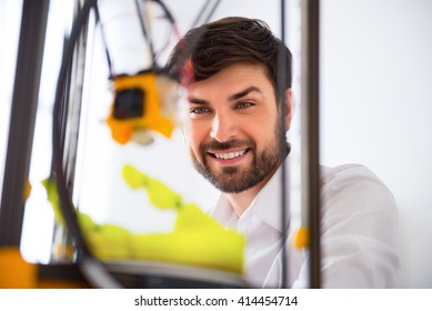 Positive man using 3d printer 