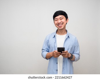 Positive Man Using Mobile Phone With Gentle Smile Isolated