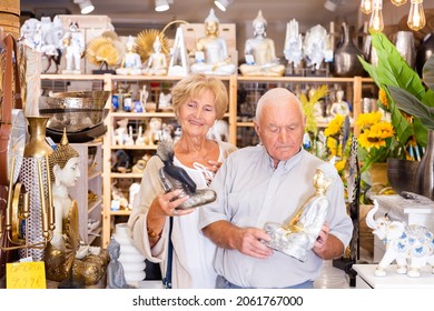 Positive Mature Couple Looking For Small Statue For Home Decor At Household Store