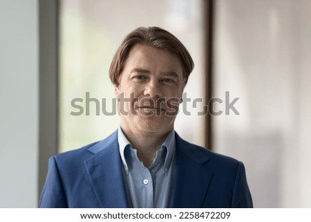 Positive middle aged business leader man in formal jacket head shot portrait. Confident mature male CEO, company owner, director, boss, businessman looking at camera, smiling