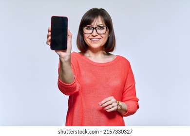 Positive Middle Aged Woman Showing Smartphone Screen