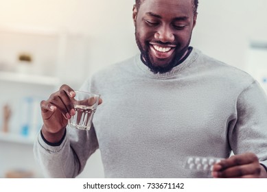 Positive Minded African American Man Taking Medication