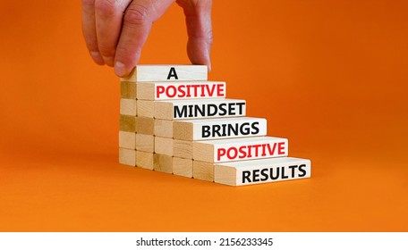 Positive Mindset Symbol. Wood Blocks With Words A Positive Mindset Brings Positive Results. Beautiful Orange Background Businessman Hand. Business Motivational Positive Mindset Concept. Copy Space.