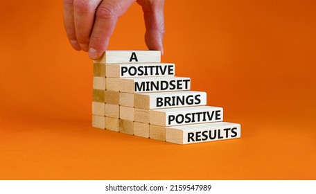 Positive Mindset Symbol. Wood Blocks With Words A Positive Mindset Brings Positive Results. Beautiful Orange Background Businessman Hand. Business Motivational Positive Mindset Concept. Copy Space.