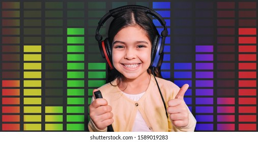 Positive Mixed Race Girl Wearing Headphones Getting Hearing Test, Audiometry, Sound Equalizer On The Background. Child Hearing Exam