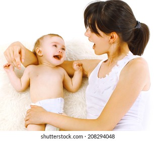 Positive mom and baby having fun in bed