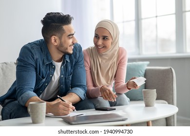 Positive Muslim Family Counting Their Spendings, Feeling Wealthy