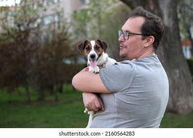 Positive Not Shaved, Not Combed Plus Size Man With Jack Russell Puppy In His Arms