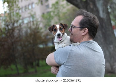 Positive Not Shaved, Not Combed Plus Size Man With Jack Russell Puppy In His Arms