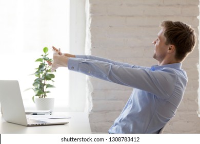 Positive Office Worker Distracted From Work Doing Effective Stretching Exercises During The Working Day. Businessman Get Rid Of Muscle Pain Relieve Tension In Sedentary Work, Healthy Lifestyle Habit