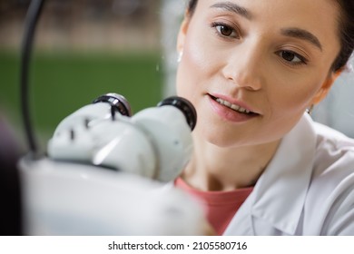 positive optometrist working with vision screener on blurred foreground