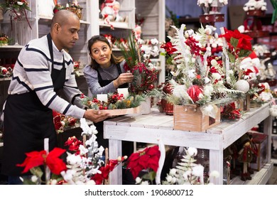 Positive Owner And Assistant Of A Flower Shop Prepares Christmas Decorations And Arrangements