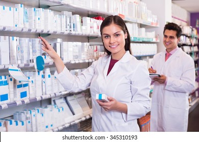 Positive Pharmacist And Pharmacy Technician Posing In Drugstore