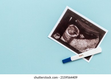 Positive pregnancy test with ultrasound picture of unborn baby - Powered by Shutterstock