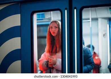 Positive Redhead Young Female In Subway Train Behind The Door