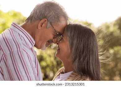 Positive senior caucasian wife hugging husband, want to kiss in park, close up. Couple enjoy tender moment, romantic date and active lifestyle, love and relationship outdoor - Powered by Shutterstock