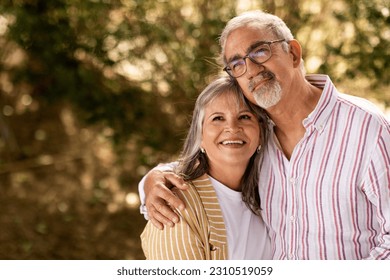 Positive senior man hug woman in casual, enjoy walk together, romantic date in park outdoor. Love, relationships, free time and weekend, retirement and lifestyle, ad and offer - Shutterstock ID 2310519059