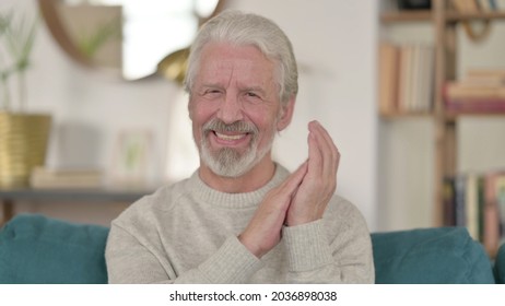 Positive Senior Old Man Clapping At Home