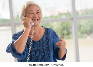 Positive senior woman talking on the phone