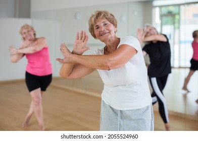 Positive Senior Women In Sportswear Dancing In Fitness Room.