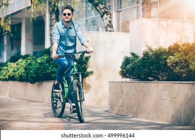 Positive Smiling Guy Riding A Bike