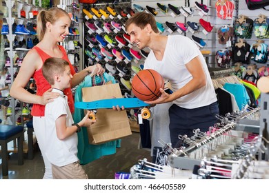 Positive smiling young parents giving skateboard to their son in school age in sport store - Powered by Shutterstock