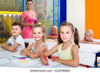 positive spanish children sitting together and studying in class at school  - Shutterstock ID 1221940825