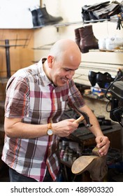 Positive Specialist Fixing Heel Taps Of Shoes On Machine