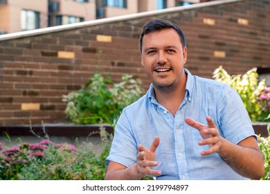 Positive talking mature man looking at camera, outdoor backyard at recreational area. Male webcam recording interview. Talking gesturing man looking at camera.  - Powered by Shutterstock