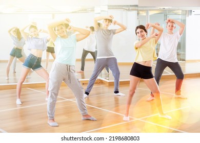 Positive Teenage Dancers Doing Dance Workout During Group Class