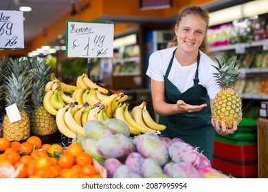 Positive Teenage Girl At Her First Job, Selling Pineapple In Vegetable Store