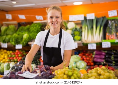 Positive Teenage Girl At Her First Job, Selling Sweet Plums In Vegetable Store