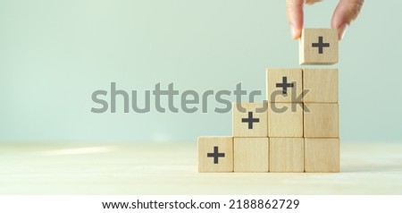 Positive things; added value, benefits, additional, personal development, growth mindset, positive thinking, opportunities, emerging market. Putting the cubes with plus sign to offer positive things. Foto stock © 