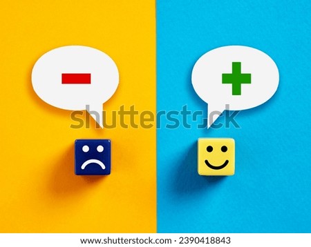 Positive versus negative thinking or mindset. Cubes with happy and unhappy faces with plus and minus symbols in speech bubbles.