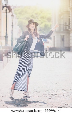 Similar – Blonde thin woman with hat and sunglasses visiting the city during the day.