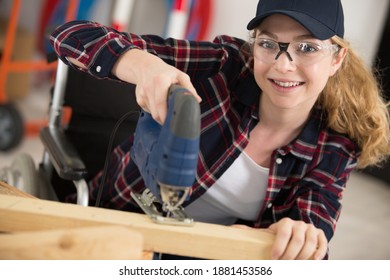 A Positive Woman Cutting Wood