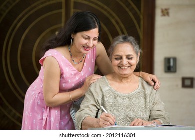 Positive woman and her daughter resting, spending time together at home