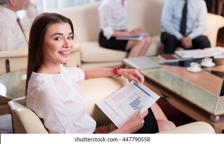 Positive Woman Sitting In The Arm Chair