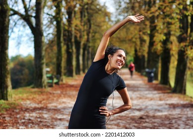 positive woman stretching outdoors preparing for exercise in sportswear - Powered by Shutterstock