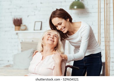 Positive woman taking care of her disabled grandmother - Shutterstock ID 529634521