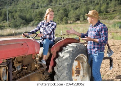 Positive Woman Working On Small Farm Tractor. High Quality Photo