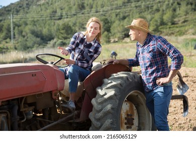 Positive Woman Working On Small Farm Tractor. High Quality Photo