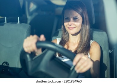 Positive Young Adult Woman Driving Car During Solo Trip, Front View